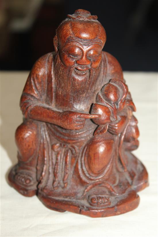 A Chinese bamboo seated figure of an immortal, 13.5cm